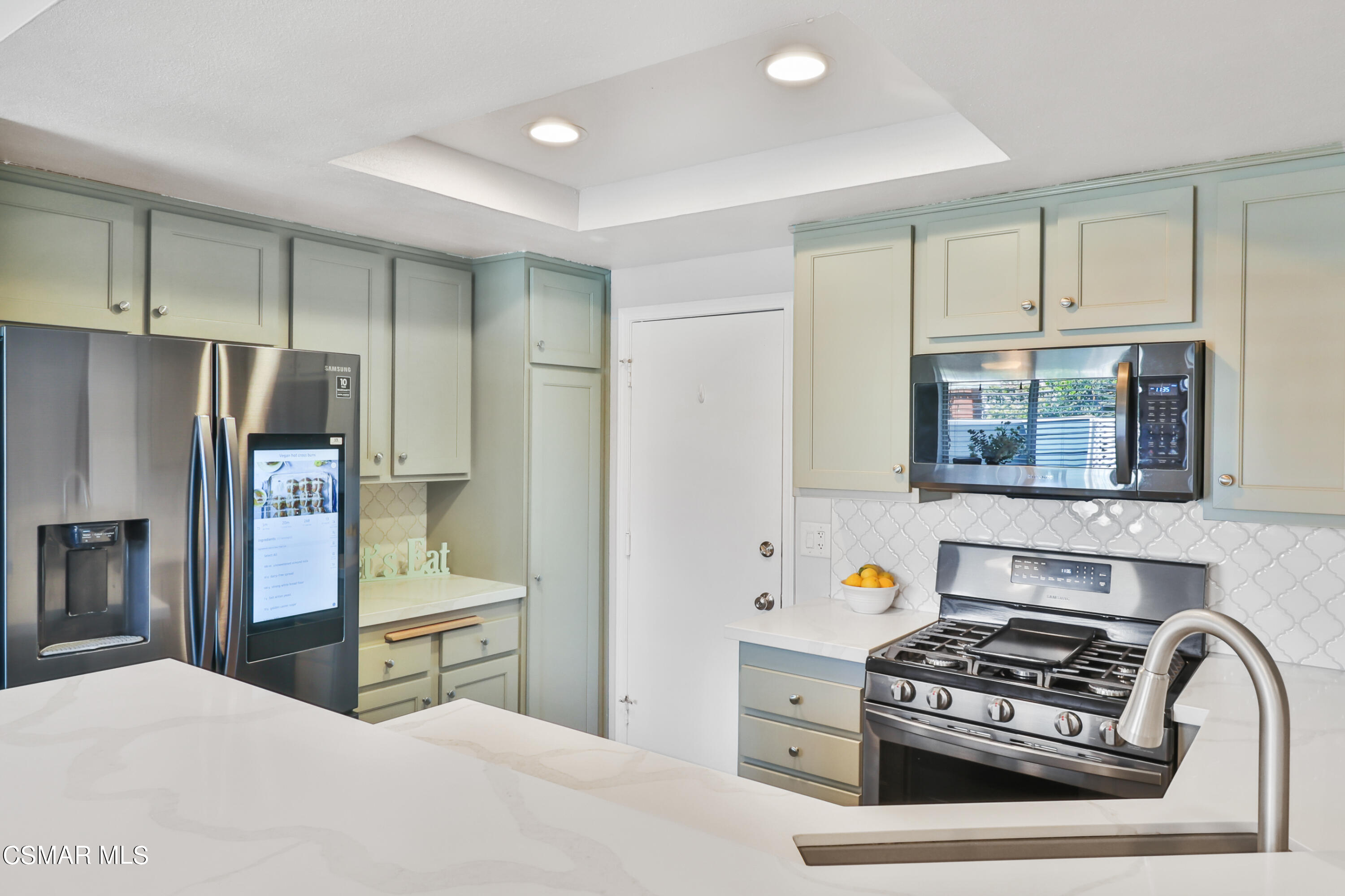 3974 Cochran Street, Unit 80 Simi Valley, CA 93063 - Photo 11 of 33 a kitchen with stainless steel appliances granite countertop a stove and a refrigerator