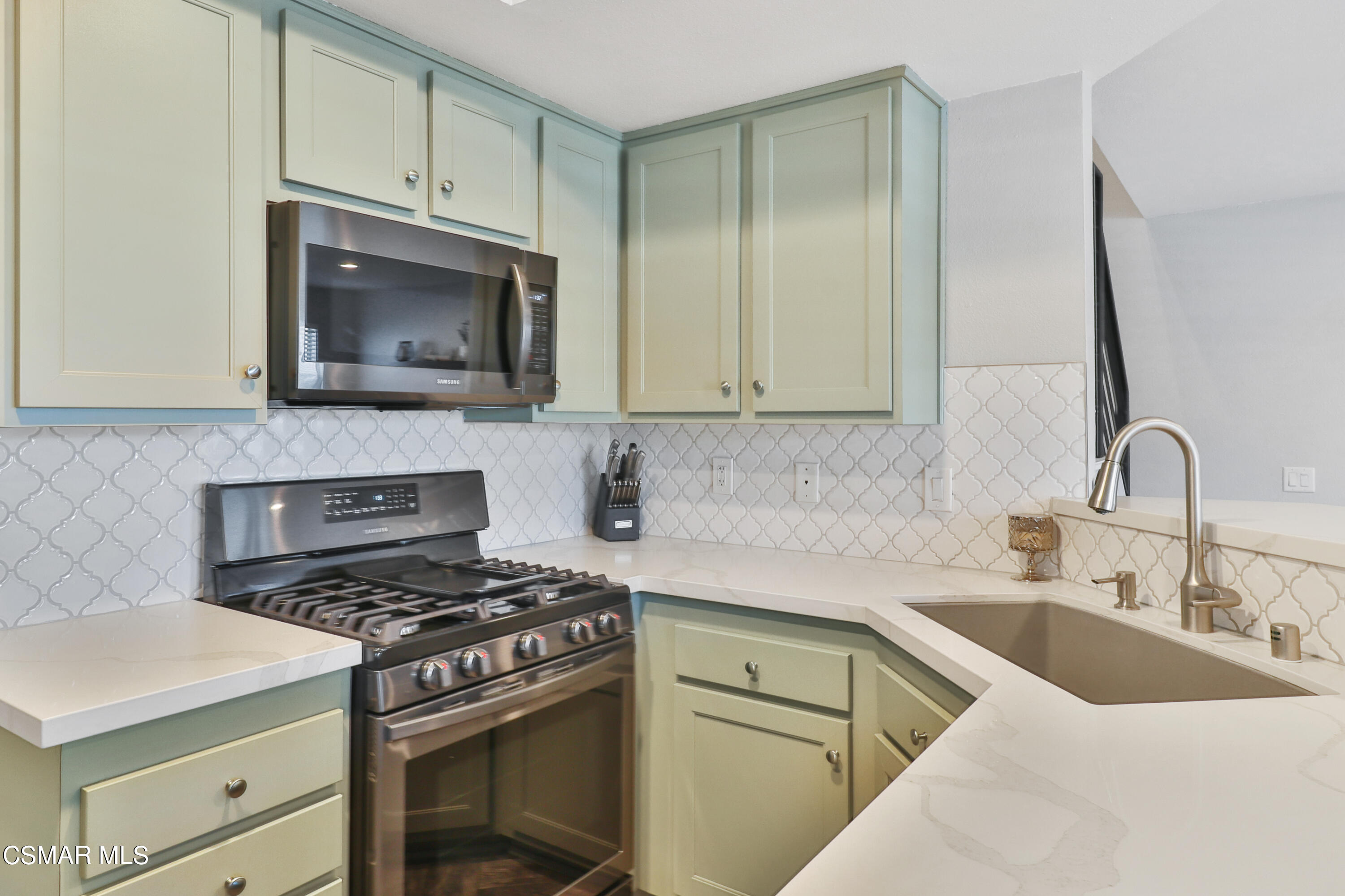 3974 Cochran Street, Unit 80 Simi Valley, CA 93063 - Photo 13 of 33 a kitchen with cabinets stainless steel appliances and a sink