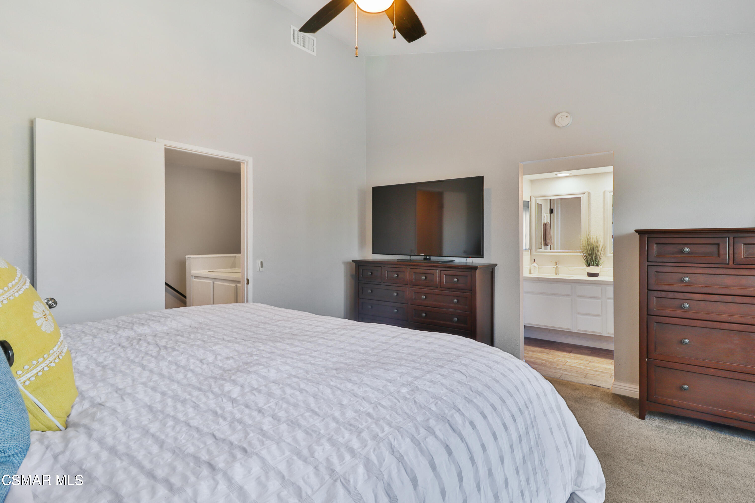 3974 Cochran Street, Unit 80 Simi Valley, CA 93063 - Photo 17 of 33 a bedroom with a bed and a flat tv screen on dresser