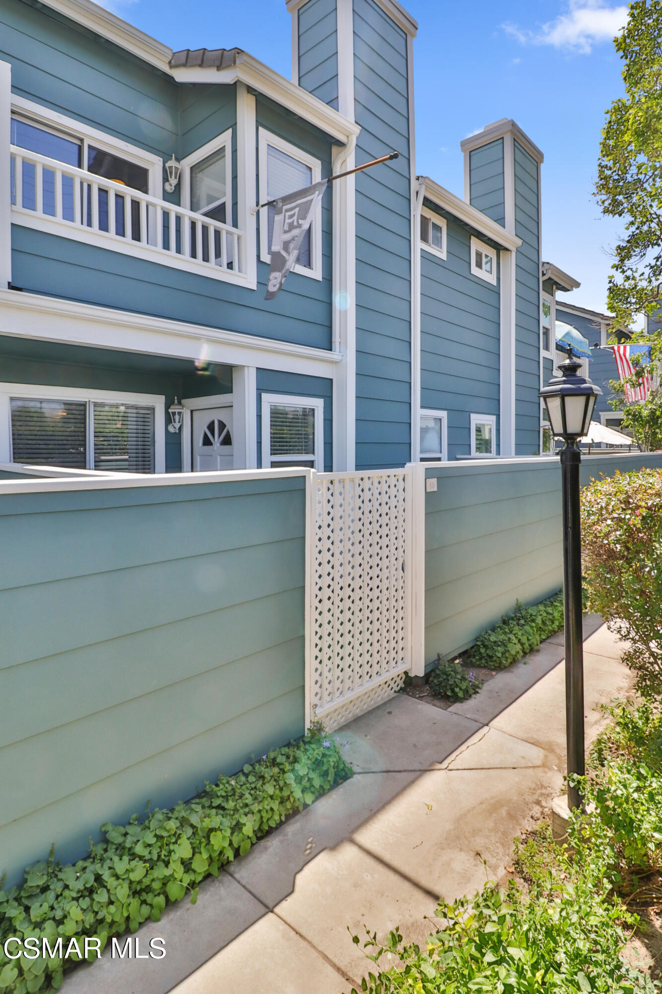 3974 Cochran Street, Unit 80 Simi Valley, CA 93063 - Photo 2 of 33 a front view of a house with a garden