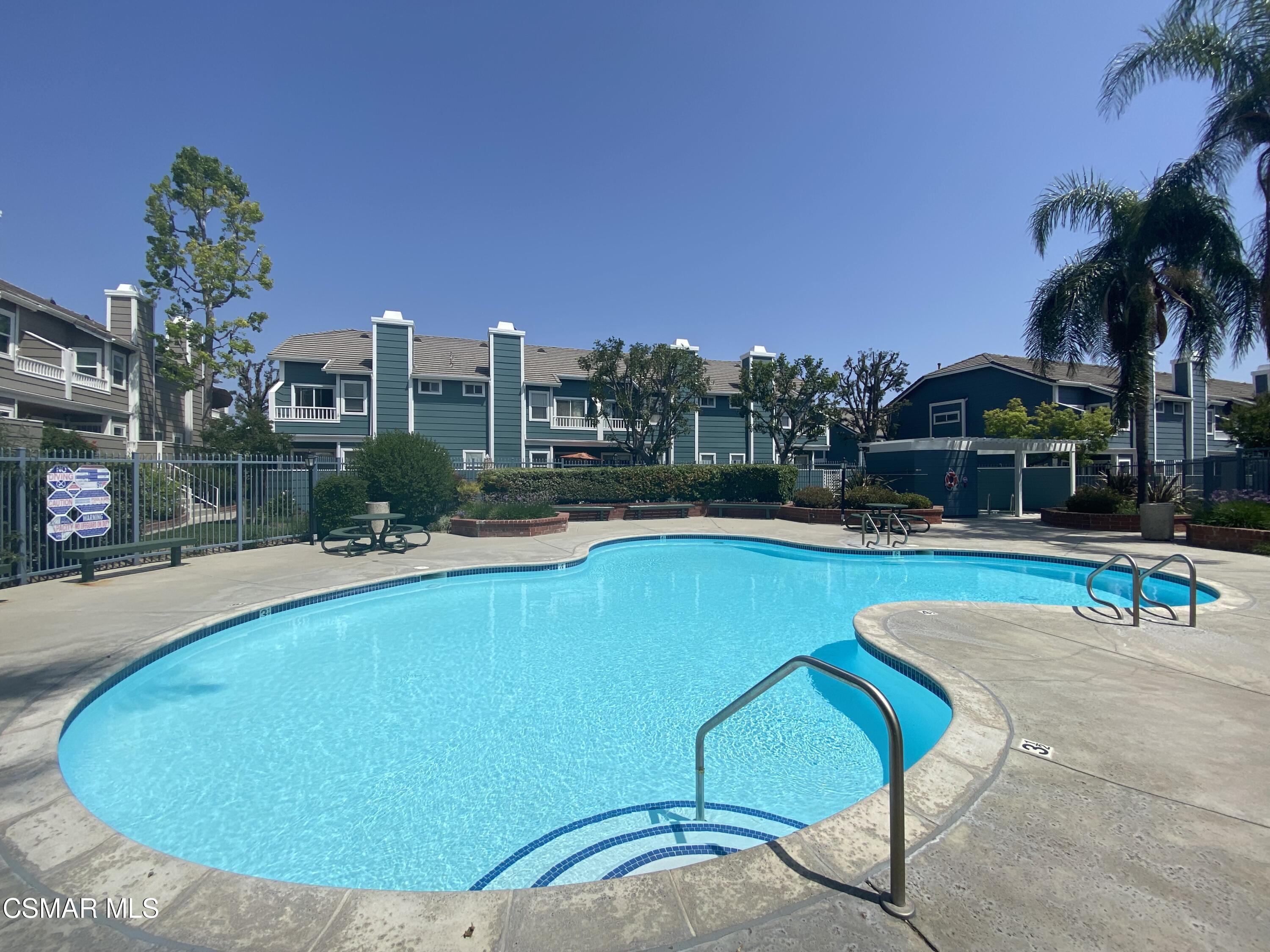 3974 Cochran Street, Unit 80 Simi Valley, CA 93063 - Photo 32 of 33 a view of a swimming pool with outdoor seating and a yard