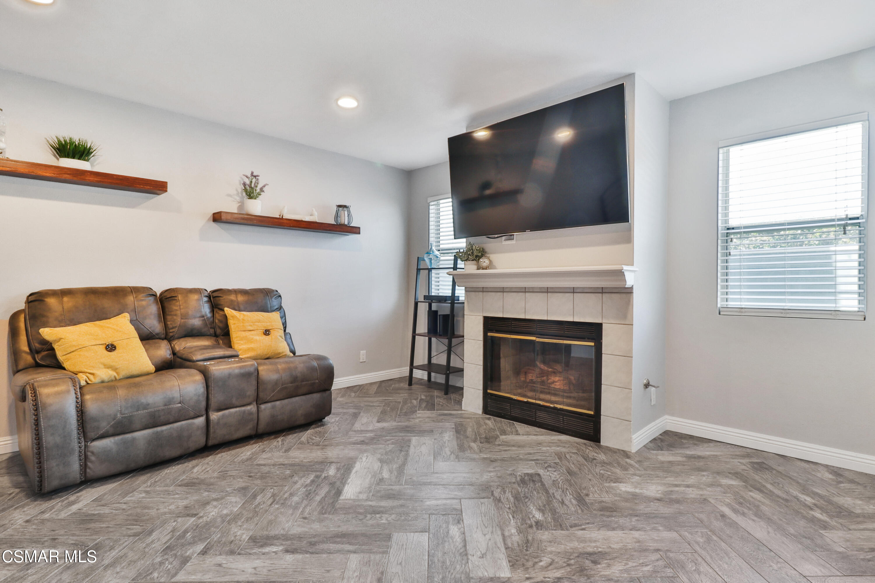 3974 Cochran Street, Unit 80 Simi Valley, CA 93063 - Photo 6 of 33 a living room with furniture a flat screen tv and a fireplace