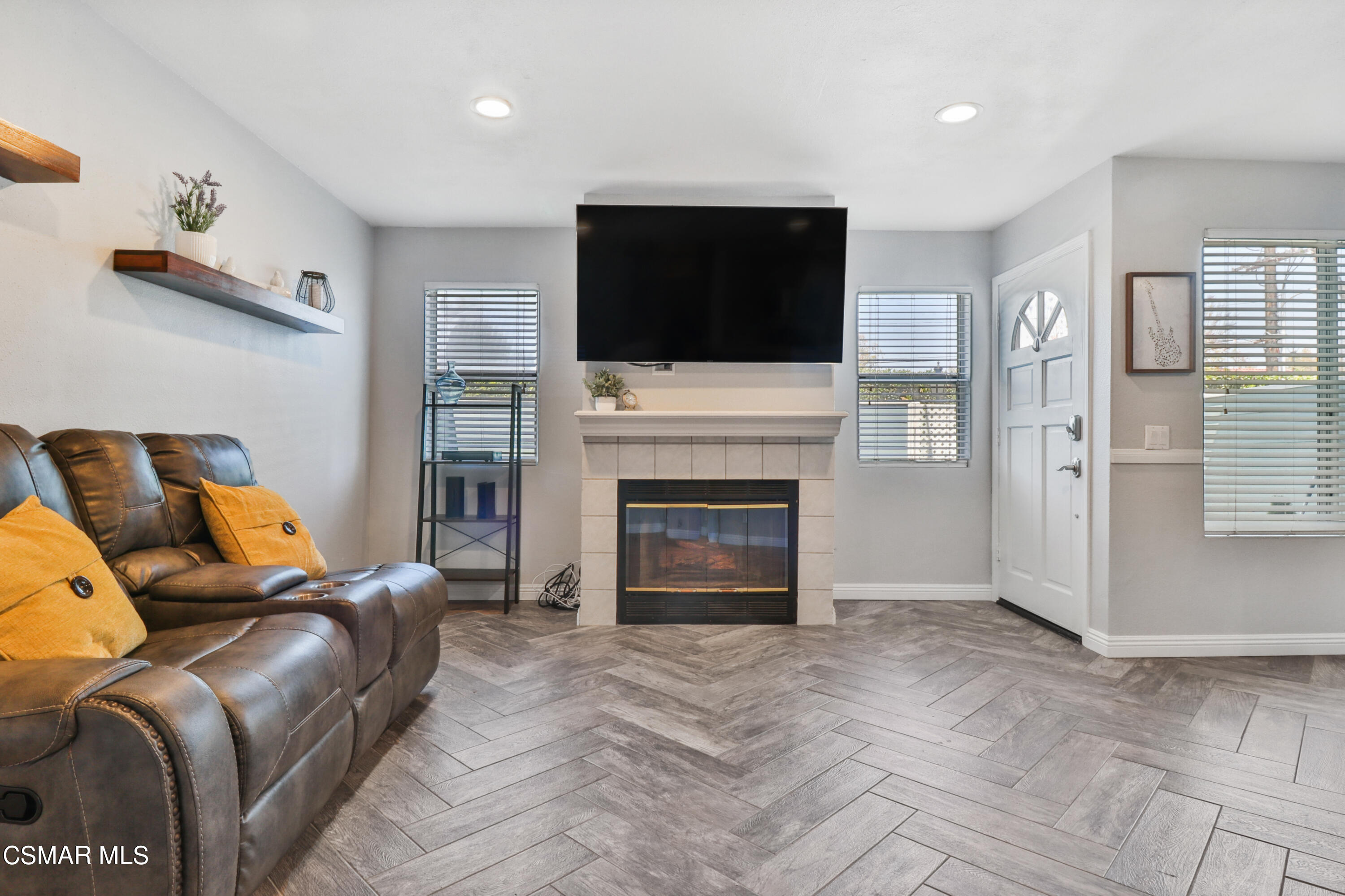 3974 Cochran Street, Unit 80 Simi Valley, CA 93063 - Photo 7 of 33 a living room with furniture a flat screen tv and a fireplace