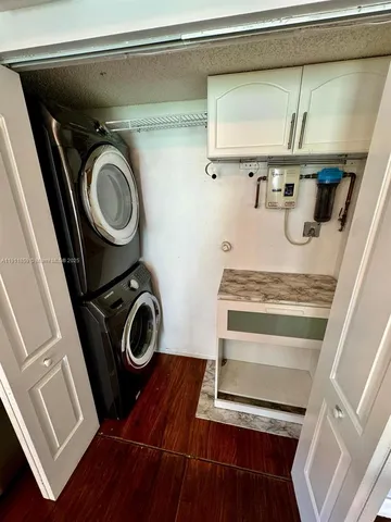 a utility room with sink dryer and washer
