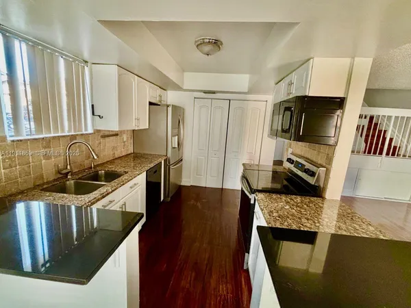 a view of a kitchen from the hallway
