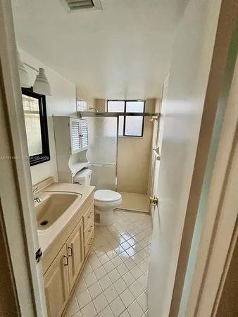 a bathroom with a sink a toilet and a shower