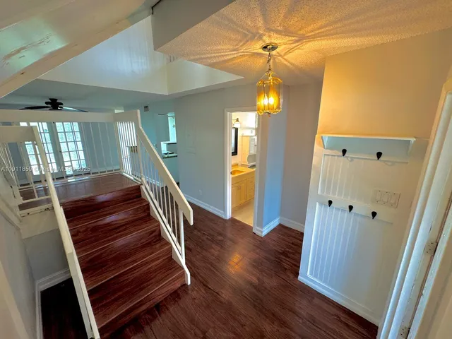 a view of entryway and hall with wooden floor