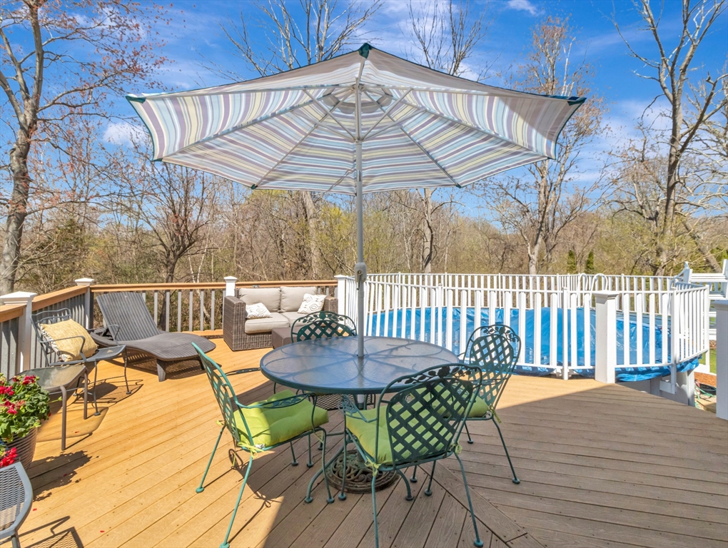 15 Riverside Drive Mansfield, MA 02048 - Photo 28 of 42 a view of a patio with a table chairs and wooden floor