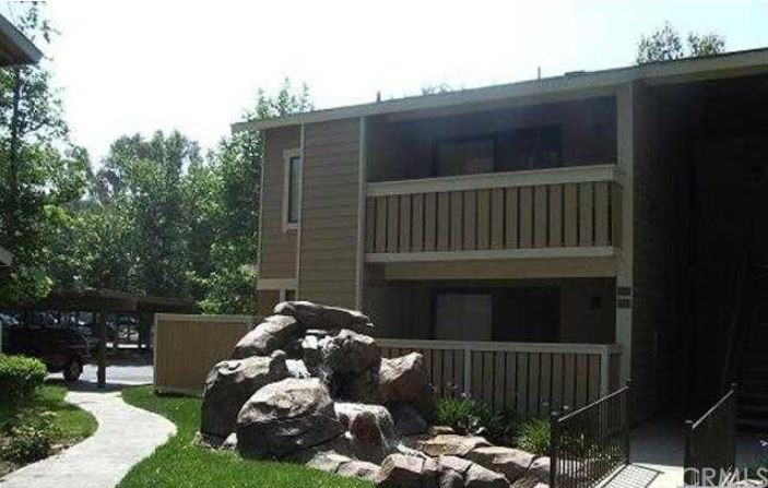 a balcony with wooden floor barbeque oven and outdoor seating