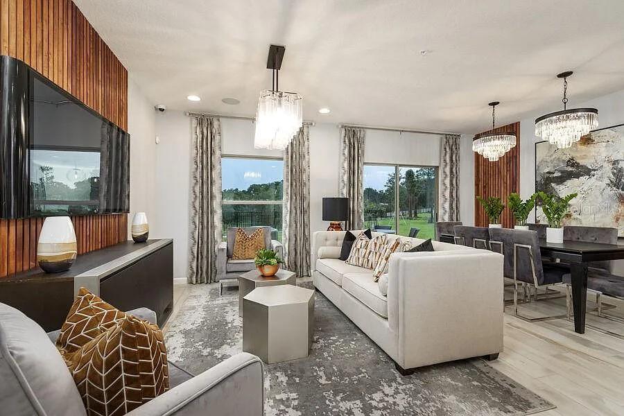 247 Smugglers Way Apopka, FL 32712 - Photo 2 of 5 a living room with furniture and a large window