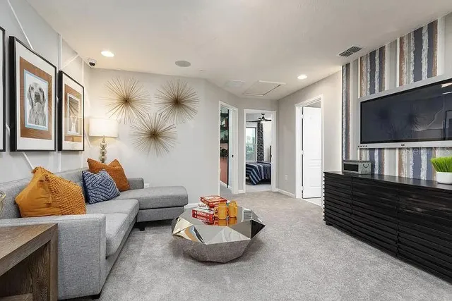 a living room with furniture and a flat screen tv