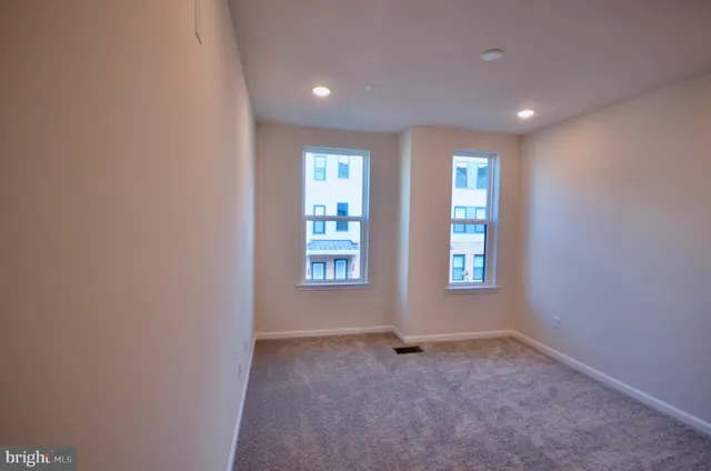 an empty room with closet and a bathroom