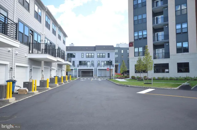 a view of a street with a building in the background