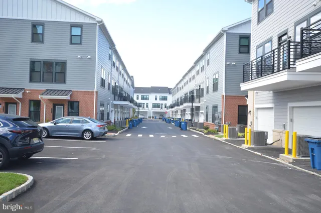 a city street lined with buildings and cars parked in front of a building