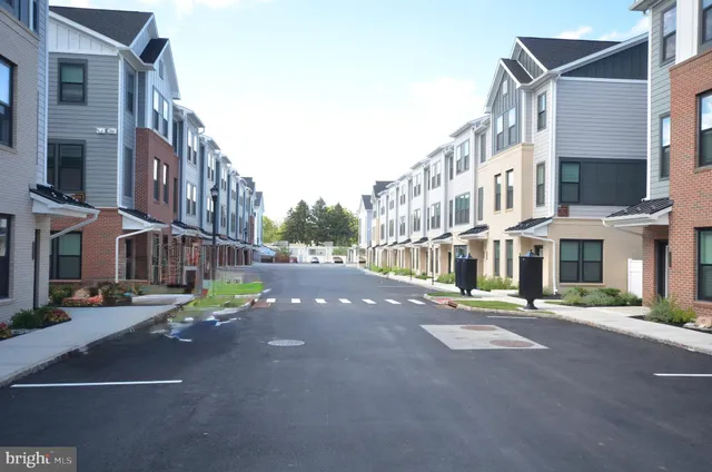 a view of parked cars in front of building