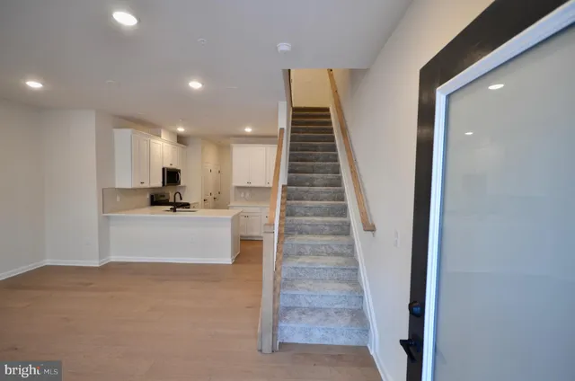 a view of kitchen with sink and refrigerator