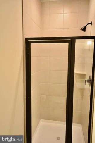 a bathroom with a glass shower door