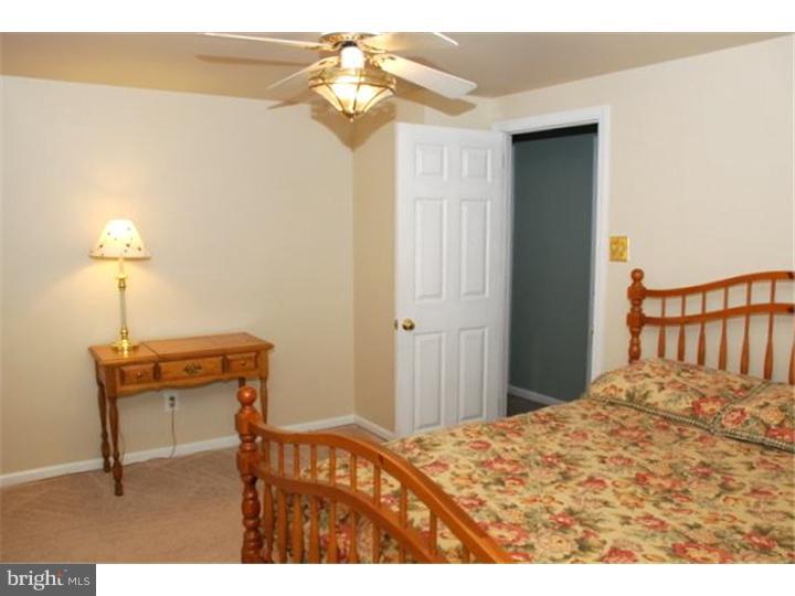 559 Tarrington Road Cherry Hill, NJ 08034 - Photo 21 of 25 a bedroom with a bed and a chandelier