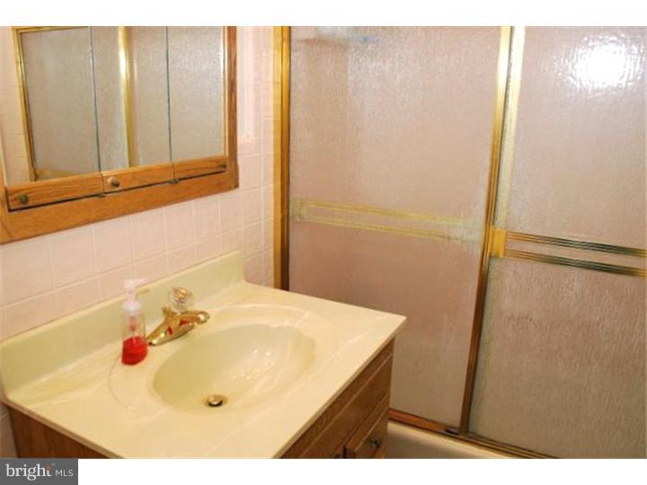 559 Tarrington Road Cherry Hill, NJ 08034 - Photo 22 of 25 a bathroom with a sink and a mirror