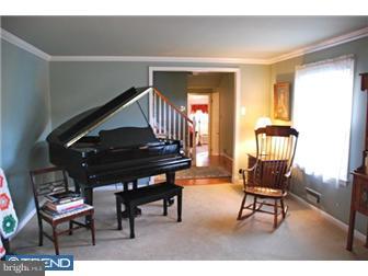 559 Tarrington Road Cherry Hill, NJ 08034 - Photo 6 of 25 a living room with furniture and a chair