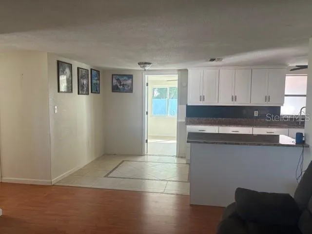 a kitchen with granite countertop a stove a sink and a refrigerator
