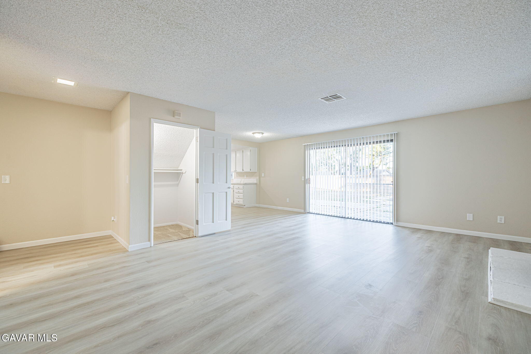 1201 Camran Avenue Lancaster, CA 93535 - Photo 21 of 49 a view of an empty room with wooden floor and a window