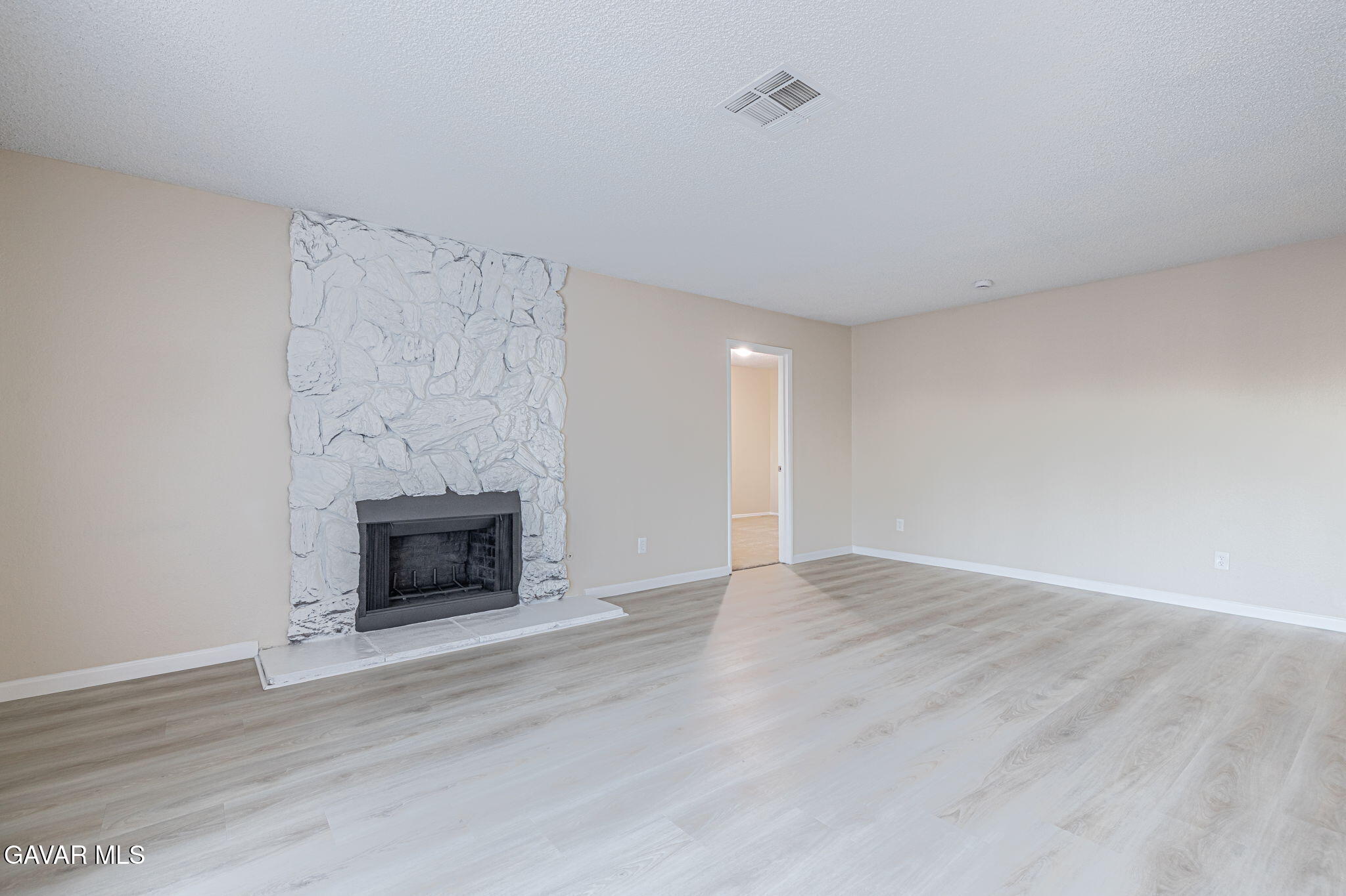 1201 Camran Avenue Lancaster, CA 93535 - Photo 24 of 49 a view of empty room with wooden floor and fireplace