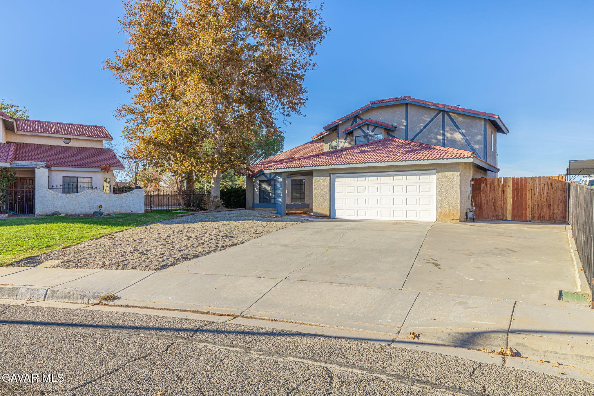 1201 Camran Avenue Lancaster, CA 93535 - Photo 28 of 49 a front view of a house with a garden and trees