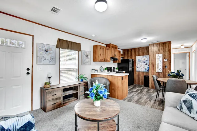 a living room with furniture a dining table and kitchen view