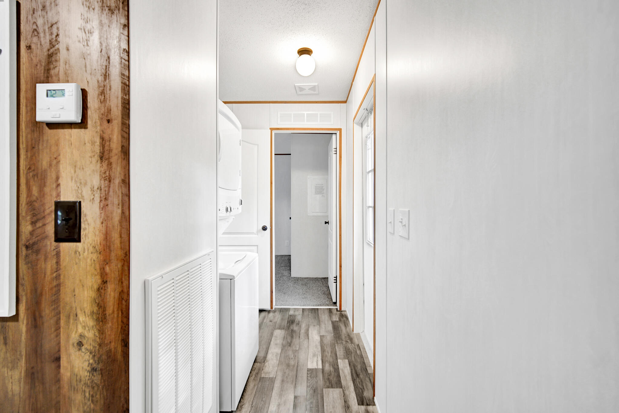 2303 Lewis Street Crestview, FL 32536 - Photo 18 of 32 a view of a hallway with wooden floor