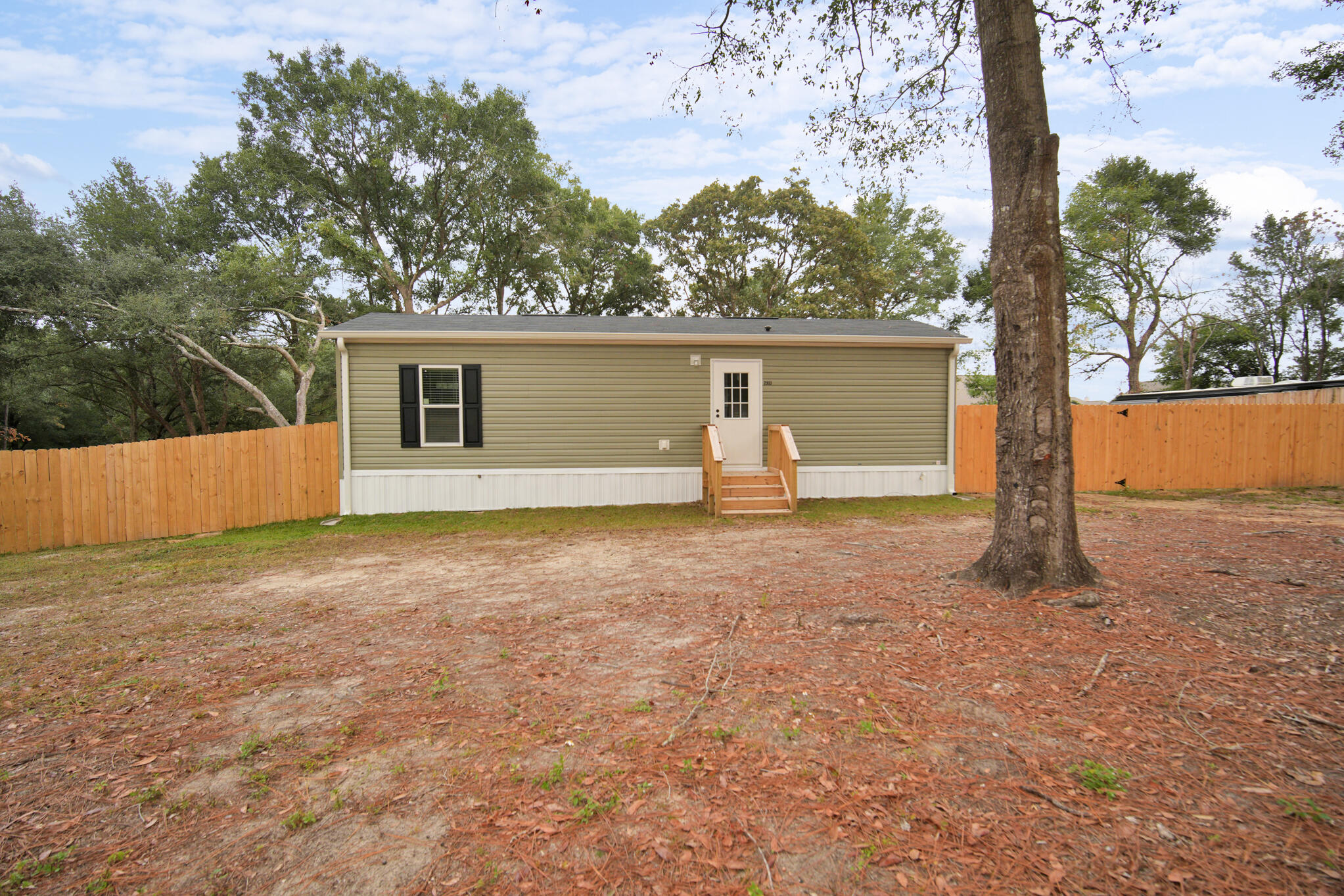 2303 Lewis Street Crestview, FL 32536 - Photo 2 of 32 a backyard of a house with table and chairs