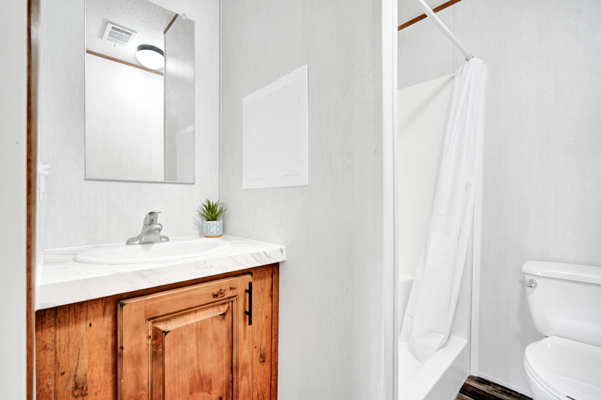 2303 Lewis Street Crestview, FL 32536 - Photo 21 of 32 a bathroom with a sink a toilet and a mirror