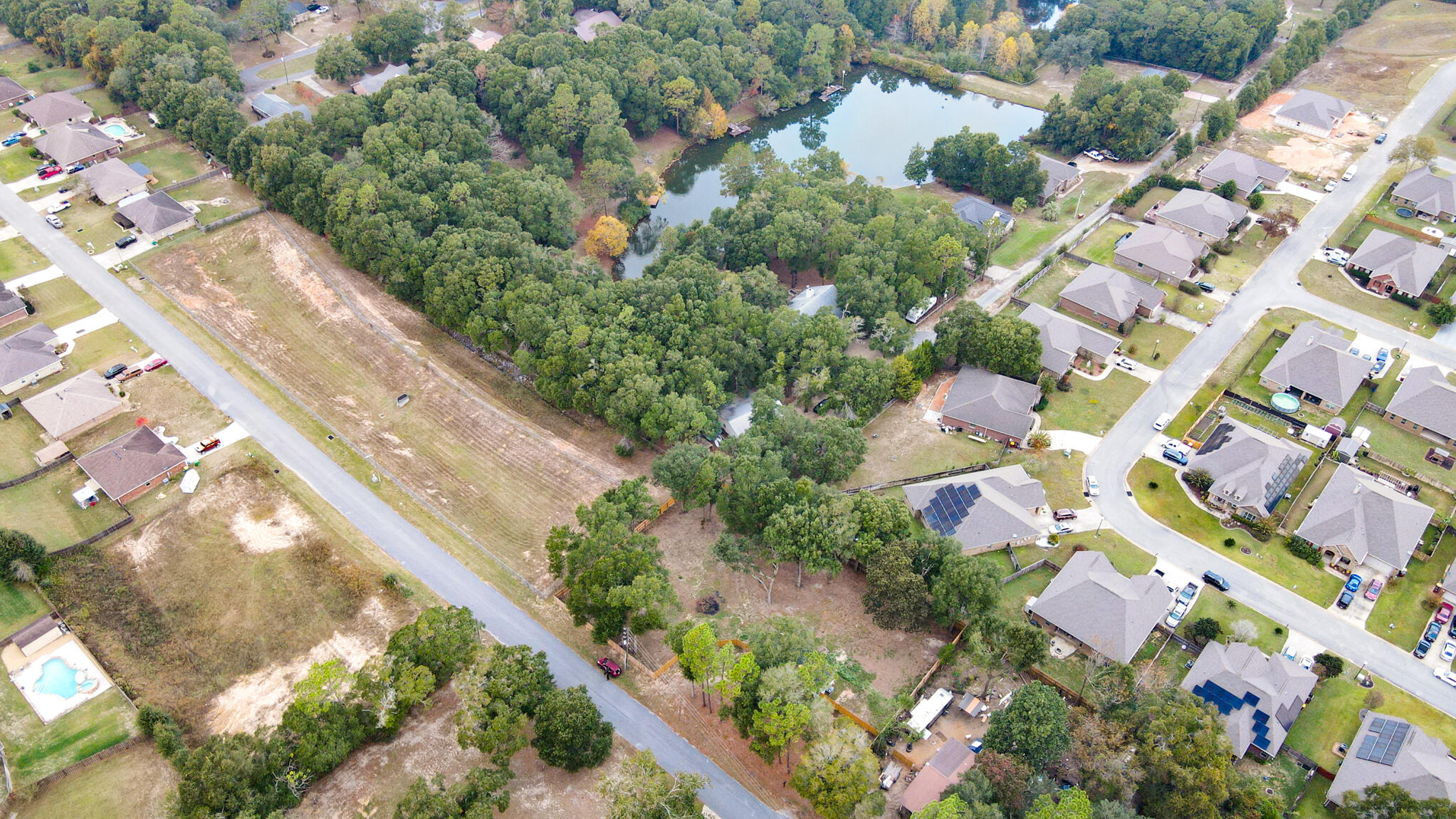 2303 Lewis Street Crestview, FL 32536 - Photo 30 of 32 an aerial view of residential houses with outdoor space