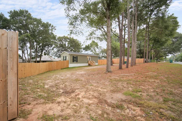 a view of outdoor space with deck and trees