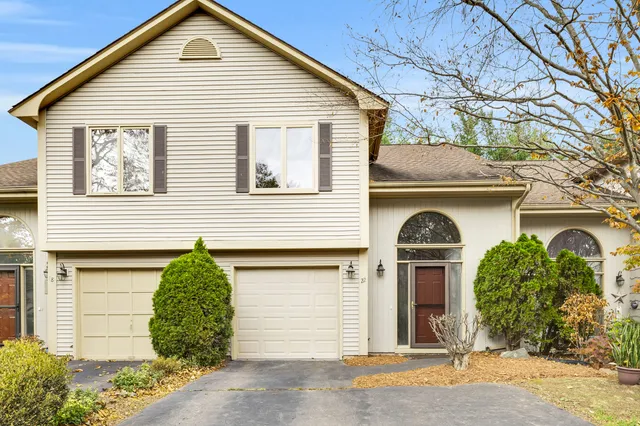 a view of a house with a garage and plants