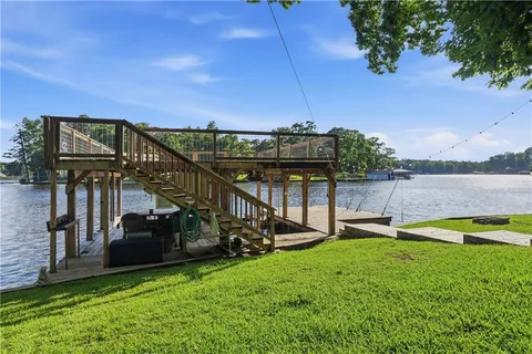 a view of a house with a yard and sitting area