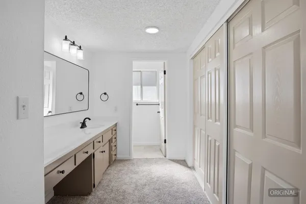 a spacious bathroom with a double vanity sink a mirror a bathtub and shower