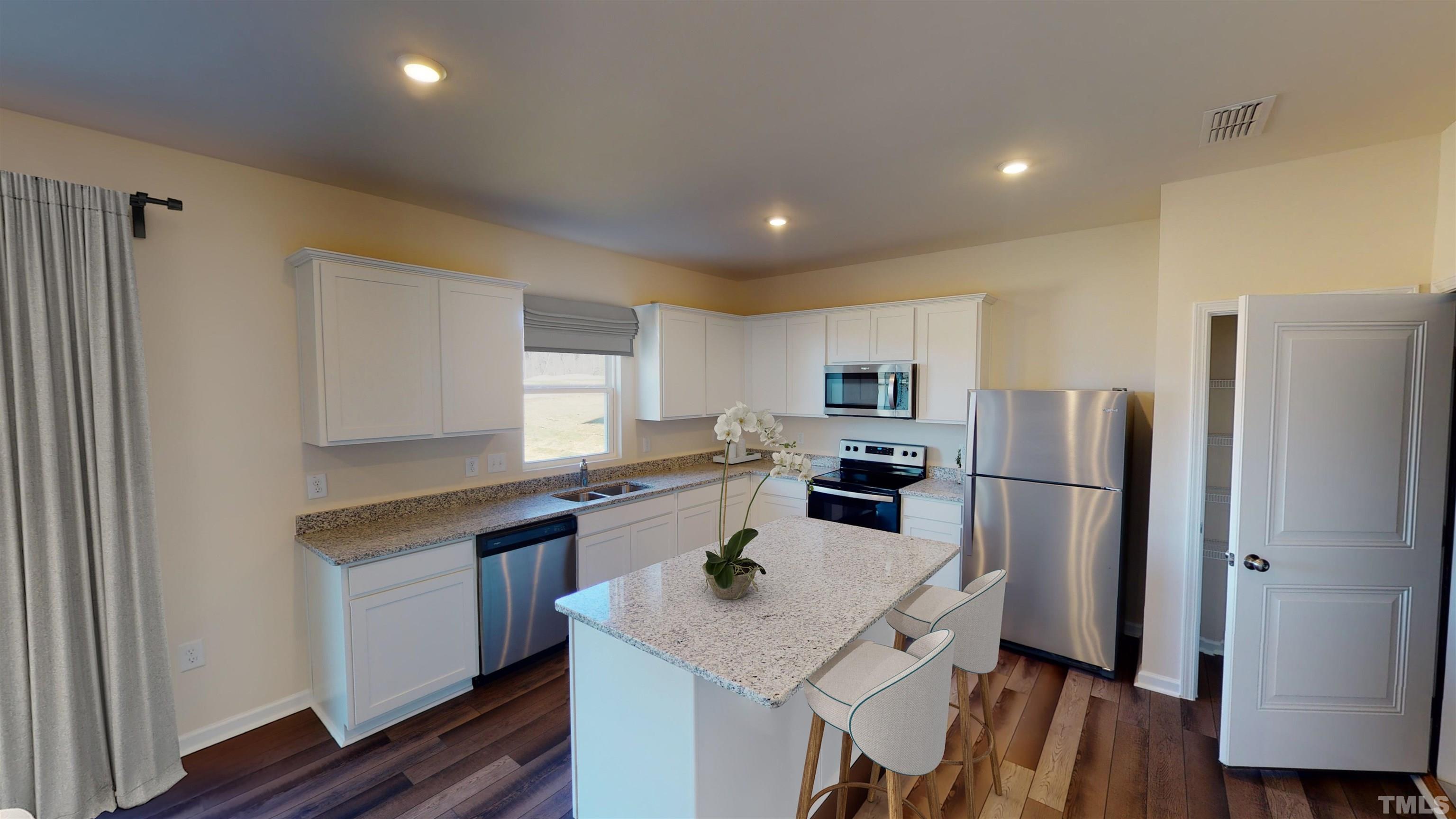 1508 Justice Union Court Raleigh, NC 27604 - Photo 8 of 25 a kitchen with refrigerator cabinets and wooden floor