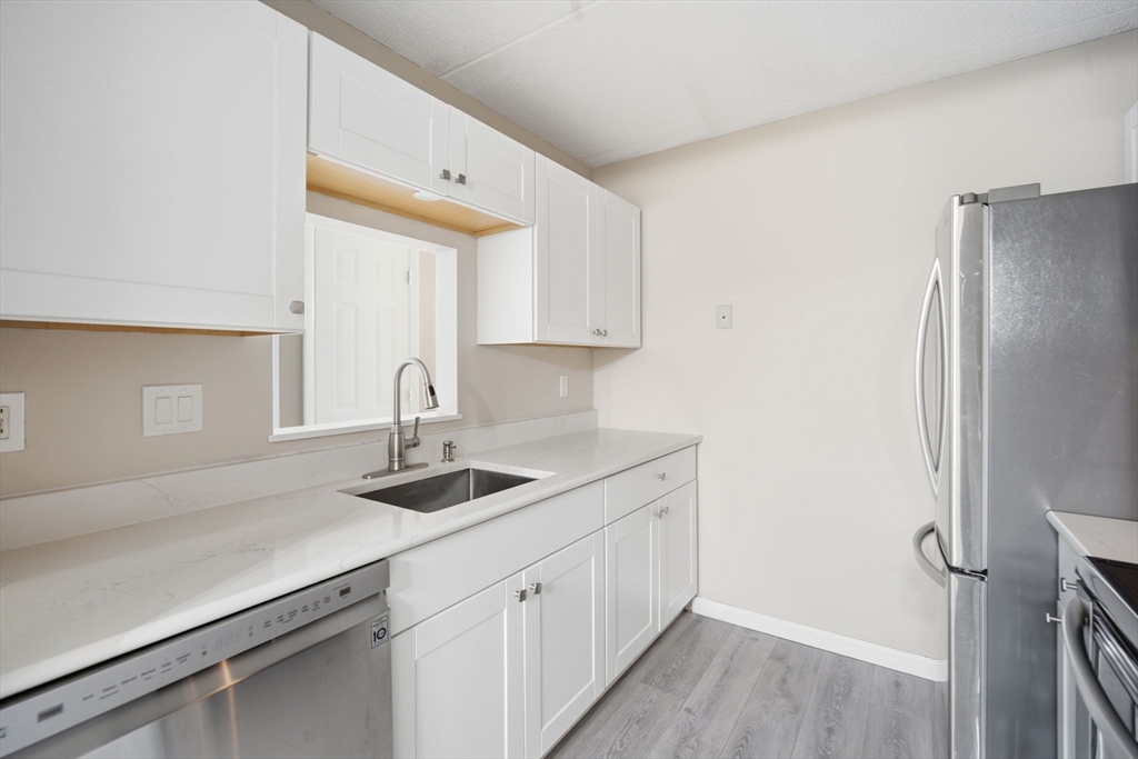 34 Maple Crest Circle, Unit B Holyoke, MA 01040 - Photo 11 of 22 a kitchen with a sink and cabinets