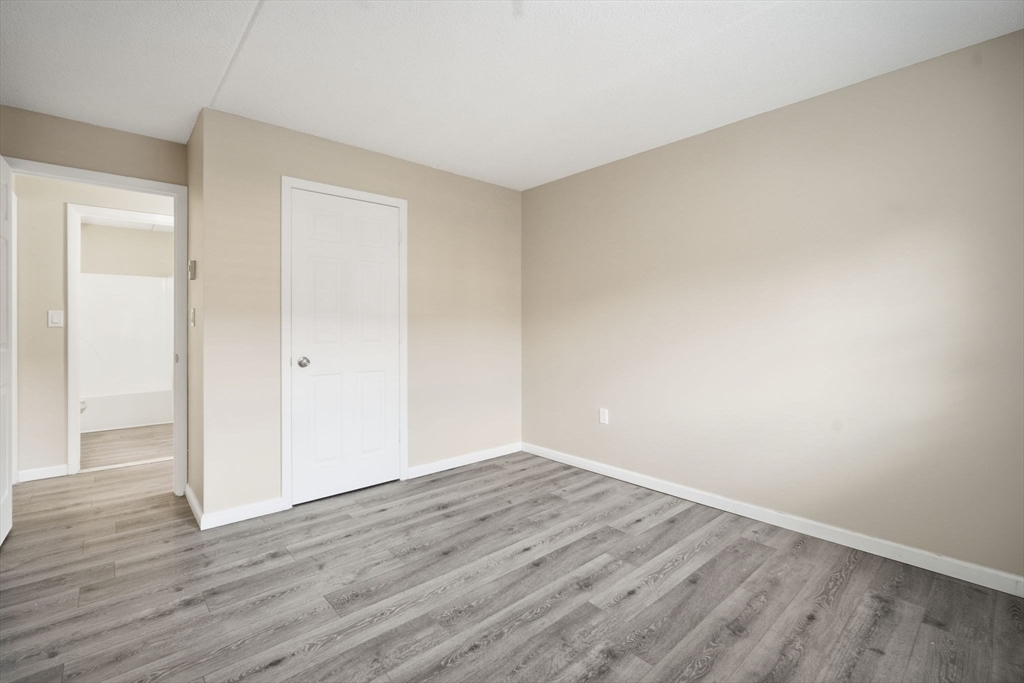 34 Maple Crest Circle, Unit B Holyoke, MA 01040 - Photo 13 of 22 a view of an empty room with wooden floor