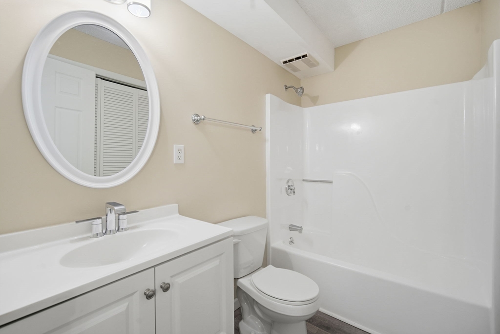 34 Maple Crest Circle, Unit B Holyoke, MA 01040 - Photo 14 of 22 a bathroom with a sink a toilet and a mirror