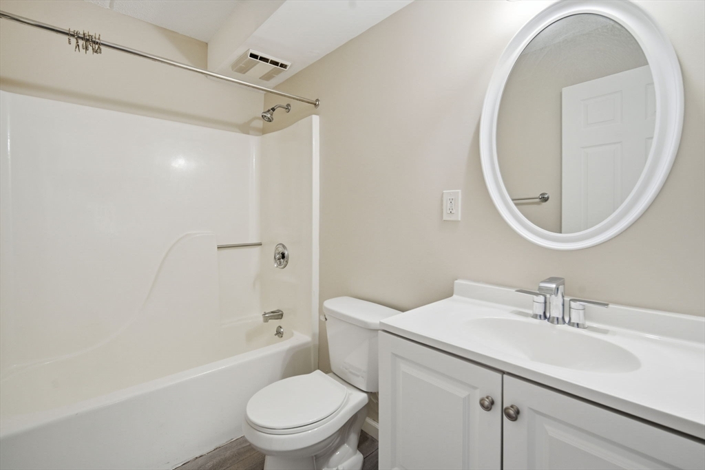 34 Maple Crest Circle, Unit B Holyoke, MA 01040 - Photo 18 of 22 a bathroom with a sink toilet and a mirror