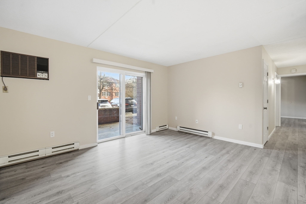 34 Maple Crest Circle, Unit B Holyoke, MA 01040 - Photo 4 of 22 an empty room with wooden floor and windows