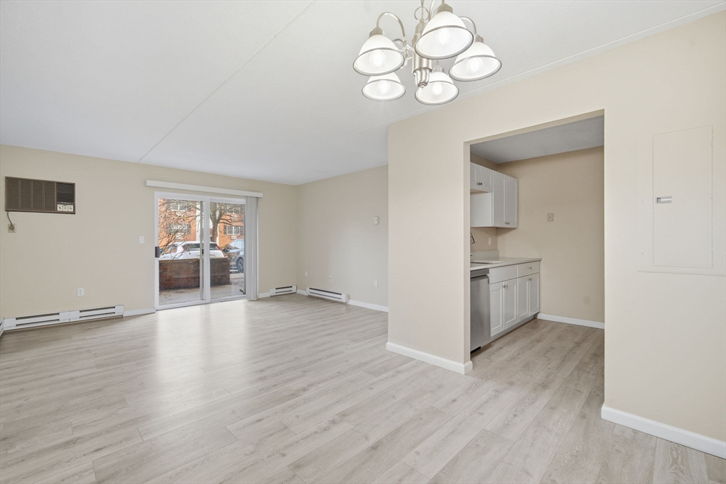 34 Maple Crest Circle, Unit B Holyoke, MA 01040 - Photo 7 of 22 a view of a kitchen with wooden floor and a window