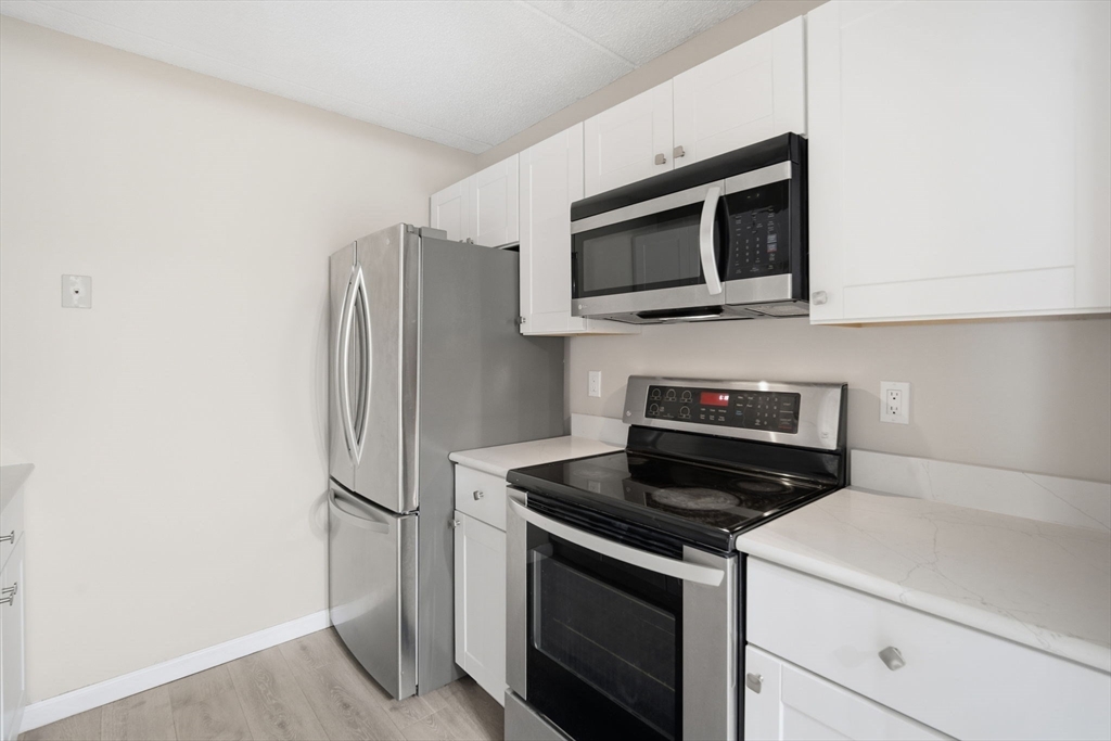 34 Maple Crest Circle, Unit B Holyoke, MA 01040 - Photo 10 of 22 a kitchen with a stove microwave and refrigerator