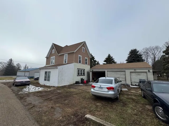 a car parked in front of white house
