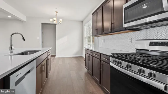 a kitchen with granite countertop stainless steel appliances and wooden cabinets