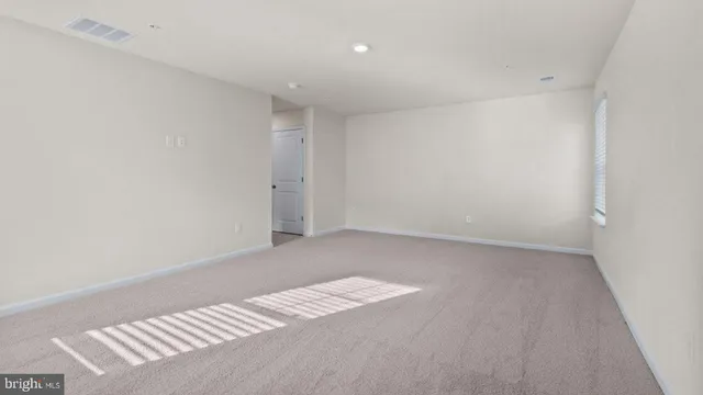 a view of an empty room and a window