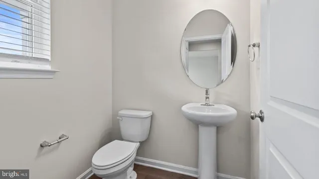 a bathroom with a toilet a sink and a mirror