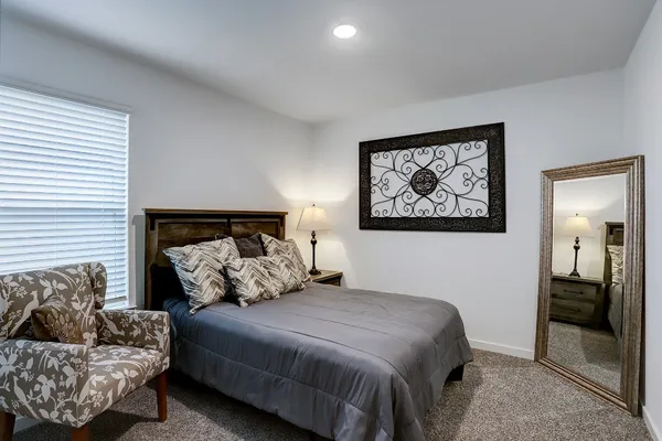 a bedroom with a bed and couch